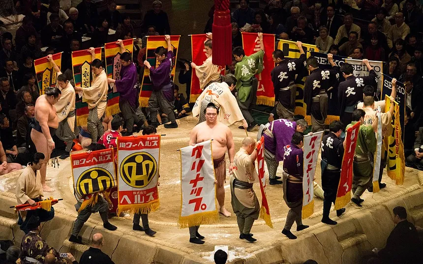 Sponsor banners paraded around the ring before a bout