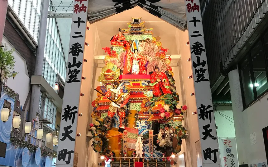 A decorated float on display in the Shintencho arcade, layered with warrior figures and castles