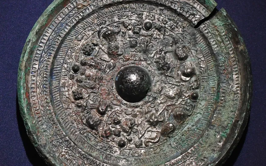 A triangular-rimmed bronze mirror with gods and beasts, from the Kanbara Jinja burial mound in Shimane: the type of mirror the exhibition is about