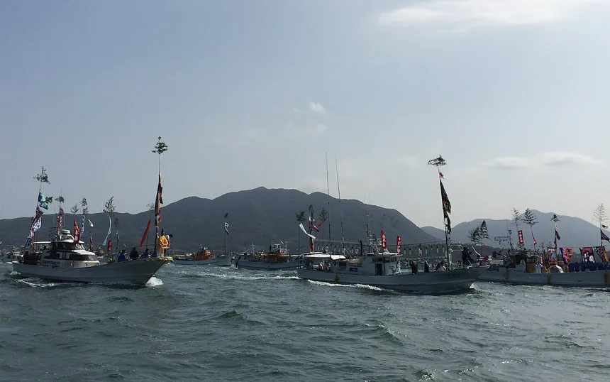 Fishing boats flying their big-catch flags in the sea procession of the Miare-sai, 1 October 2014
