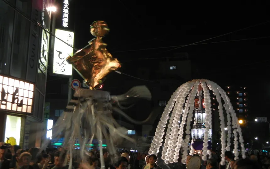 A lantern tower and a fireman’s standard in the night procession through Ikegami, 2011
