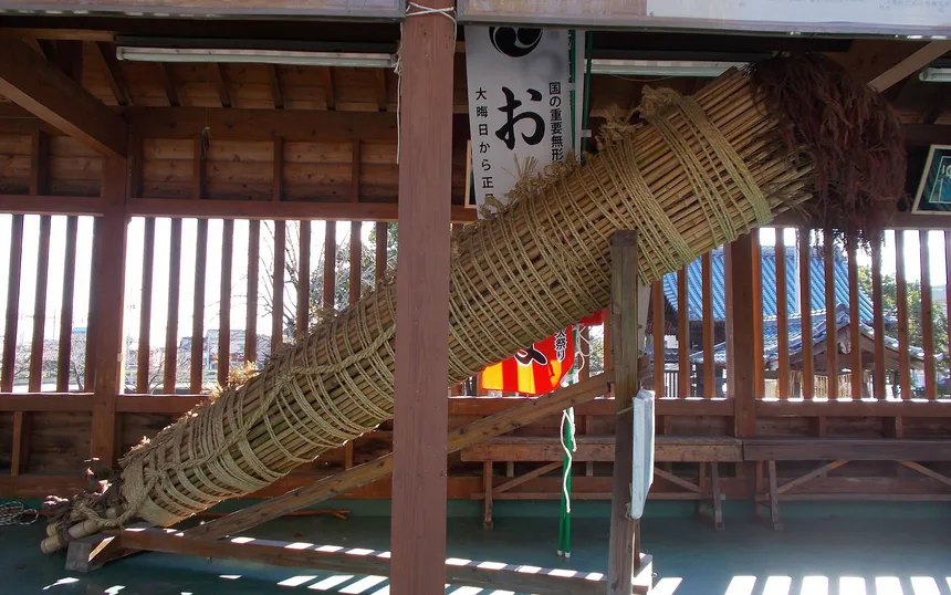 One of the great torches of bound bamboo resting under a roof at Daizenji Tamataregu