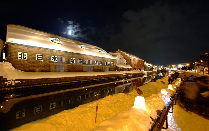 Candles in the snow beside the canal warehouses in Otaru, 2014