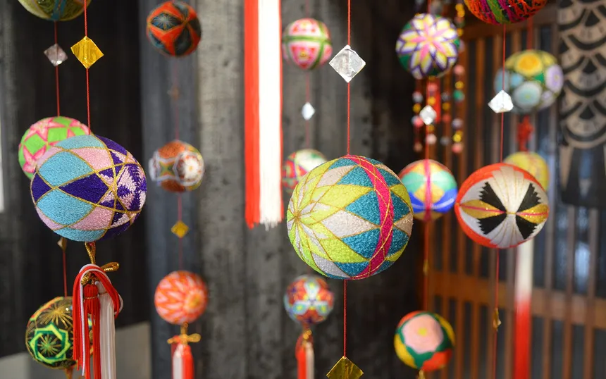 Close view of sagemon: bright wound-thread balls hanging on cords