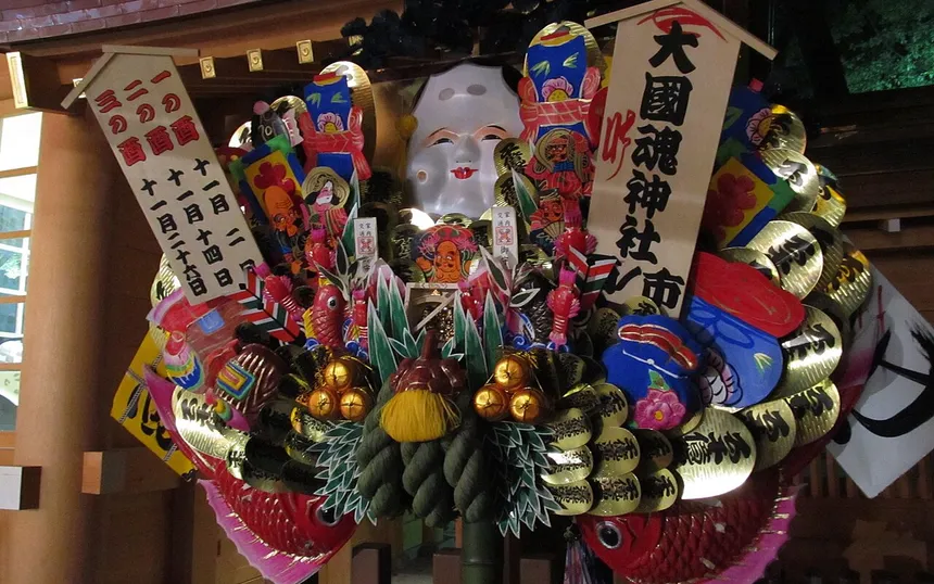 A large kumade rake with masks and gold coins; this one at Okunitama Shrine, Fuchu